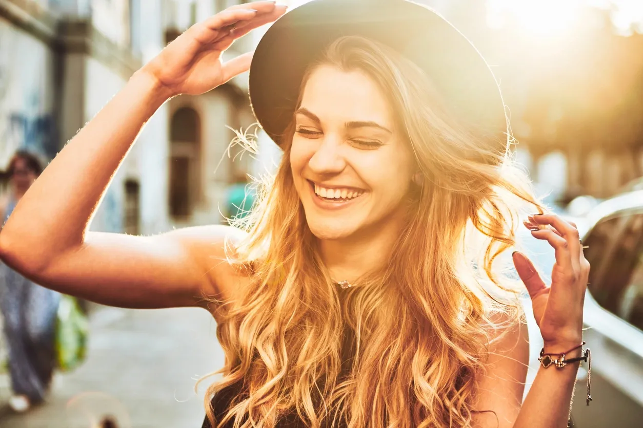 Smiling woman in hat in the sunshine